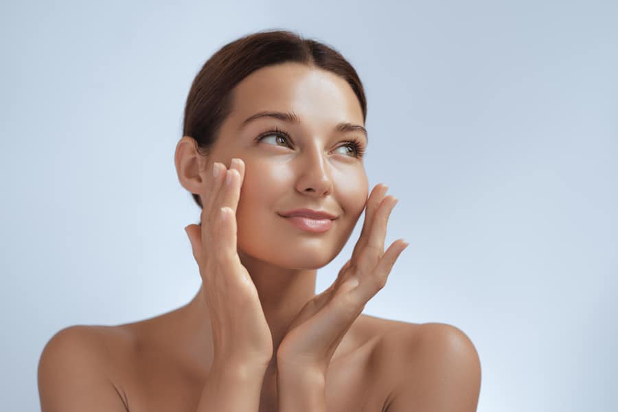 A woman with radiant skin and a joyful expression, promoting enhanced respiratory and skin health.